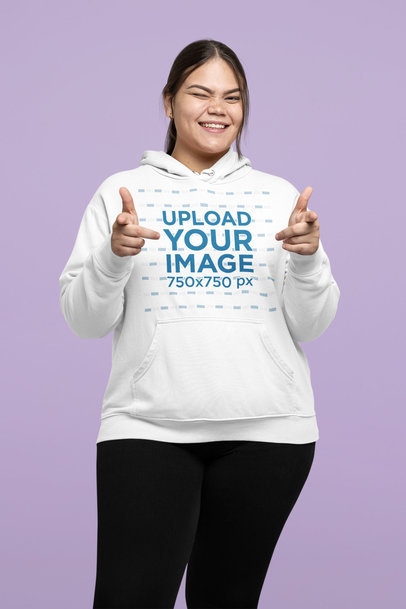 Hoodie Mockup of a Happy Woman Making Finger Guns