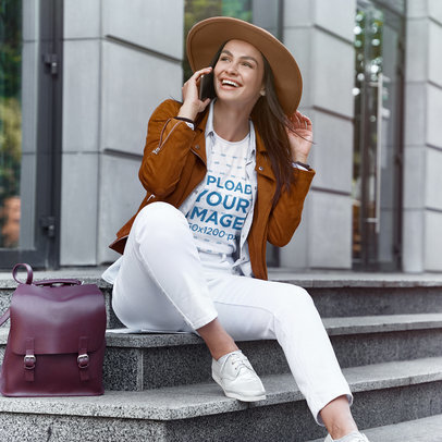 T-Shirt Mockup of a Young Woman Talking on the Phone While Sitting on Some Steps m17283-r-el2
