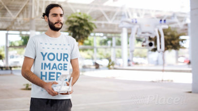 Cinemagraph Mockup of a Young Man Playing With a Helicopter While Using a Round Neck Tee