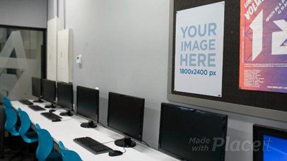 Poster Video Mockup Hanging On A Wall While A Woman Is Working On Her Lab Computer