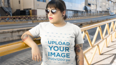 Young Girl Wearing a Plus Size T-Shirt Video and Heart Shaped-Glasses on the Street a12649