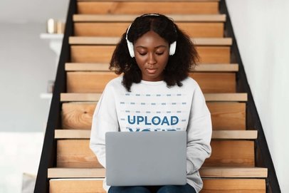 Sweatshirt Mockup Featuring a Serious Woman With Afro Hairstyle Using a Laptop