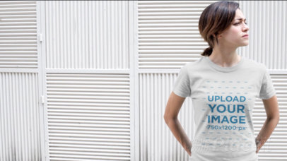 Video of a Young Woman Standing Near a White Wall Wearing a Round Neck T-Shirt