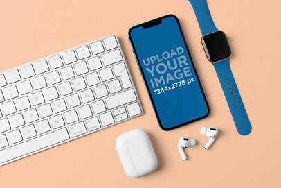 Mockup of an iPhone 13 Surrounded by Other Apple Devices