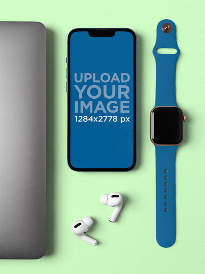 Mockup of an iPhone 13 Placed Among Some Other Devices