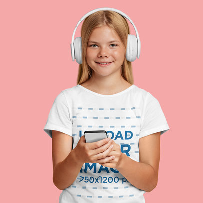T-Shirt Mockup Featuring a Smiling Teenage Girl With Headphones Using a Smartphone