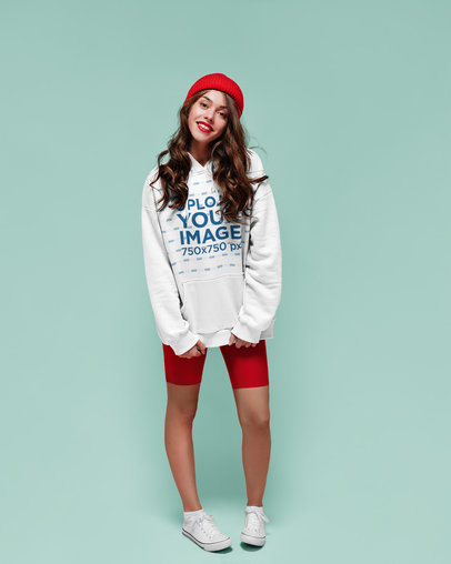 Hoodie Mockup of a Young Woman with a Cute Outfit in a Studio