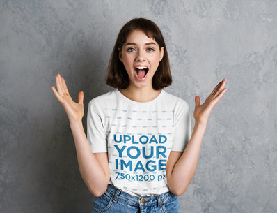 Heathered T-Shirt Mockup Featuring an Excited Woman Posing Against a Gray Wall