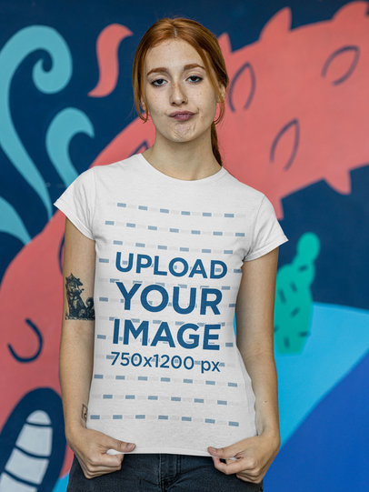 T-Shirt Mockup of a Woman with an Arm Tattoo Doing a Contempt Facial Expression