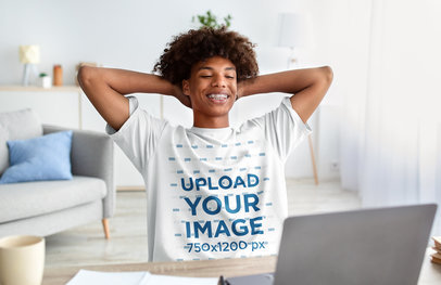 T-Shirt Mockup Featuring a Relaxed Man with Afro Hair Looking at his Laptop m16801-r-el2