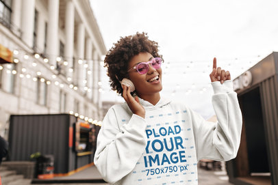 Pullover Hoodie Mockup Featuring a Woman with Headphones Happily Singing 