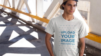 Young Dude Wearing a T-Shirt Video Mockup on a Bridge a12867