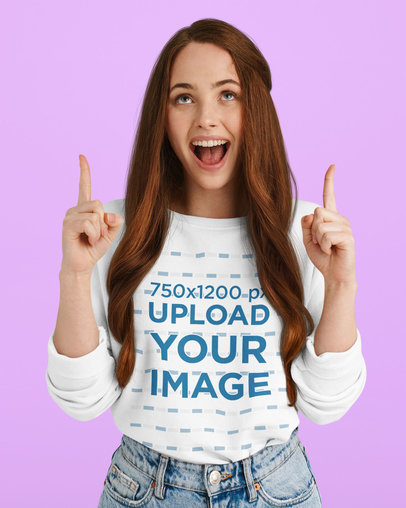 Sweatshirt Mockup Featuring a Joyful Woman Pointing up With Both Hands 
