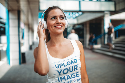 Tank Top Mockup of a Woman Smiling and Using Headphones