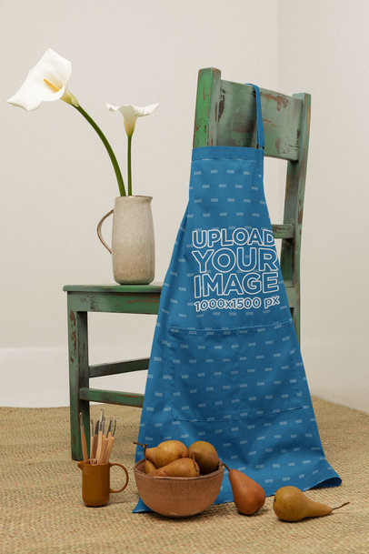 Mockup of an Apron Lying on a Green Rustic Chair 