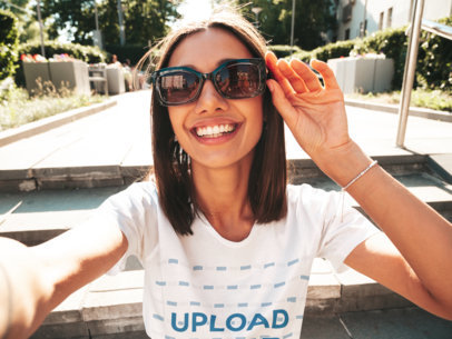 Round-Neck Tee Mockup Featuring a Happy Woman with Sunglasses Taking a Selfie