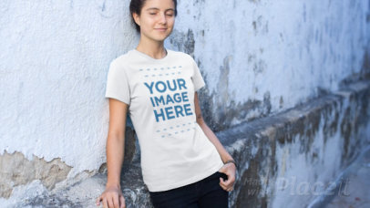 Young Woman Leaning on a Street Wall Wearing a T-Shirt Video Mockup