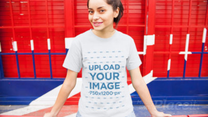 Trendy Young Girl Wearing A Tshirt Video Mockup Sitting Outside British Place a13008