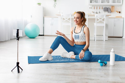 Sports Bra and Mat Mockup Featuring a Smiling Woman Filming a Fitness Video