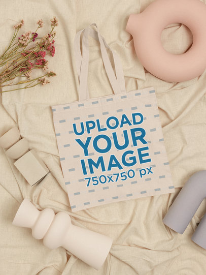 Mockup of a Tote Bag Laid Flat in a Pottery-Themed Setting m23506