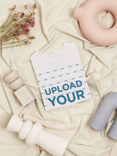 Minimal Mockup of a Folded Women's T-Shirt Surrounded by Pottery