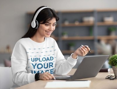 Sweatshirt Mockup of a Smiling Woman Working on Her Laptop