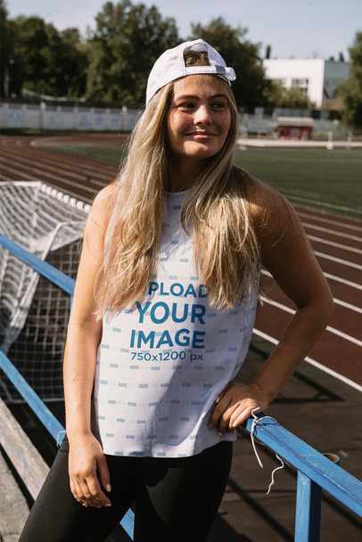 Tank Top Mockup Featuring a Teenage Girl Posing by a Running Track m16543-r-el2