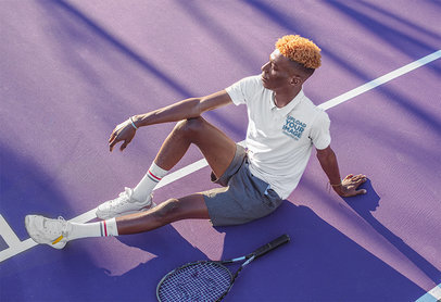 Polo Shirt Mockup of a Man Sitting on a Tennis Court