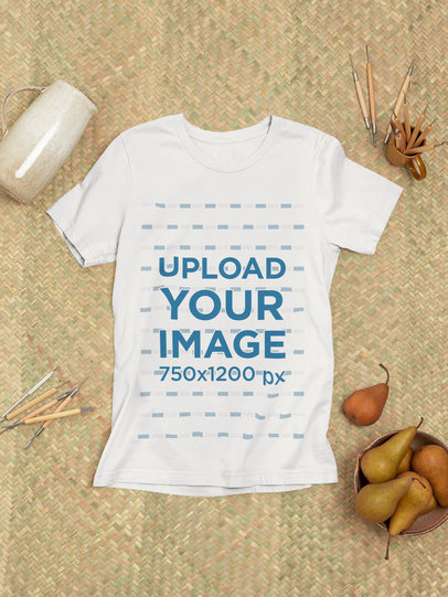 Mockup of a Bella Canvas T-Shirt Lying on a Rustic Rug