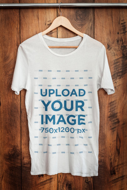 Mockup of a Heathered T-Shirt Placed on a Hanger Against a Wooden Wall