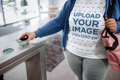 Plus Size T-Shirt Mockup of a Woman Using Her Phone to Enter the Gym m23456-r-el2