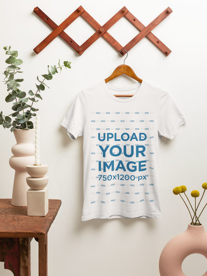 Mockup of a Bella Canvas T-Shirt on a Hanger Featuring a Rustic Setting
