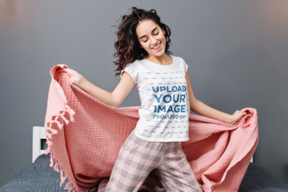 T-Shirt Mockup of a Happy Woman Wearing Pajamas in Her Bedroom