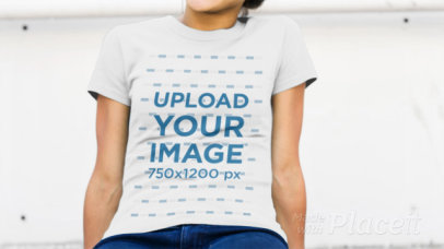 Young Skater Girl Wearing a T-Shirt Video Sitting on a Ledge and Chewing Gum a12830
