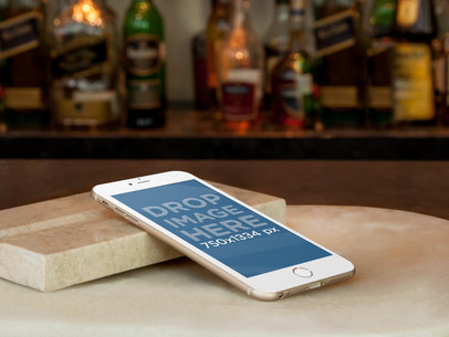 Mockup of an iPhone 6 Resting on Marble Bar Counter
