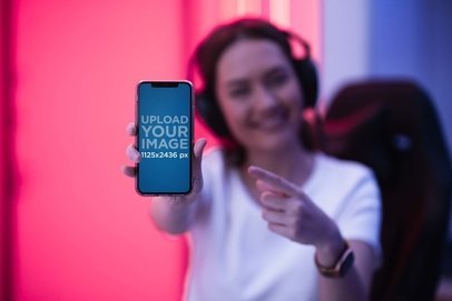 Mockup Featuring a Female Gamer Showing Her iPhone to the Camera