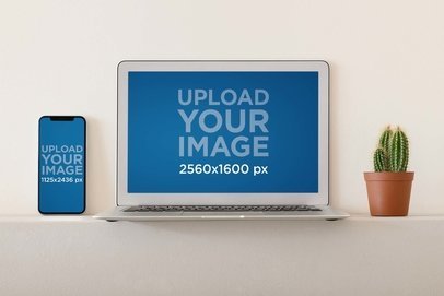 iPhone Mockup Featuring a MacBook Air and a Small Cactus