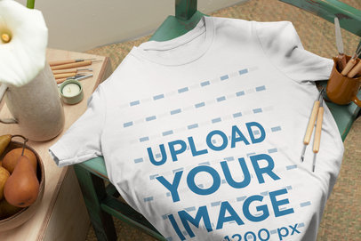 Bella Canvas T-Shirt Mockup Lying on a Green Wooden Chair m23496