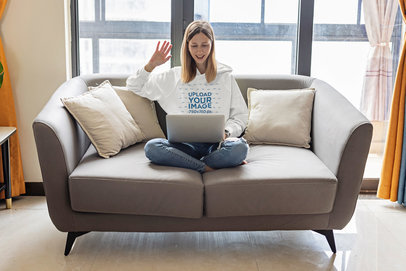 Hoodie Mockup of a Woman Doing a Video Call at Home