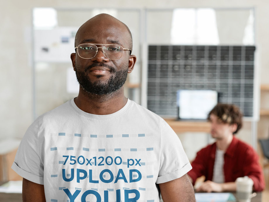 Closeup T-Shirt Mockup Featuring a Bearded Man with Glasses at Work