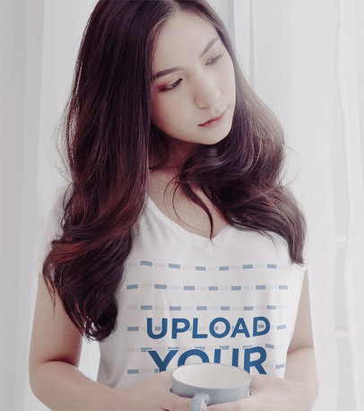 V-Neck T-Shirt Mockup Featuring a Serious Woman With a Cup of Coffee