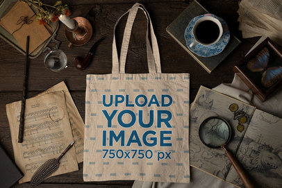 Mockup of a Tote Bag Lying on a Wooden Table and Surrounded by Vintage Objects m23740