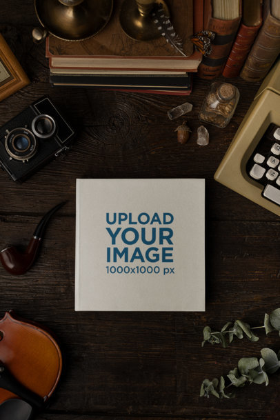 Mockup of a Book Placed Over a Wooden Table and Surrounded by Antique Objects