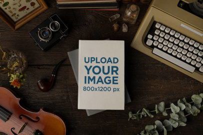 Mockup of a Book Placed over an Old Wooden Table with Antique Stuff