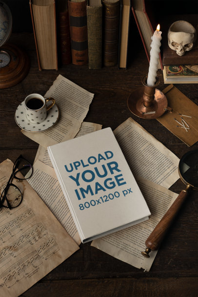 Mockup of a Book Lying over Old-Ripped Book Pages with Some Vintage Stuff