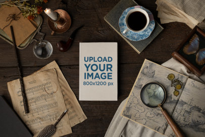 Dark Academia-Themed Mockup of a Hard Cover Book on a Wooden Table