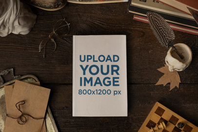 Hard Cover Book Mockup Featuring a Table with Mysterious Vintage Items