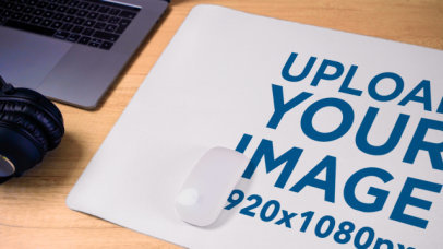 Video of a Desk Pad Lying on a Wooden Table Next to a Pair of Headphones 