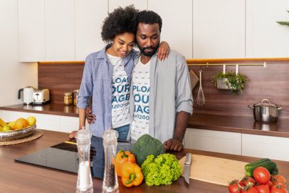 T-Shirt Mockup Featuring a Happy Couple Cooking