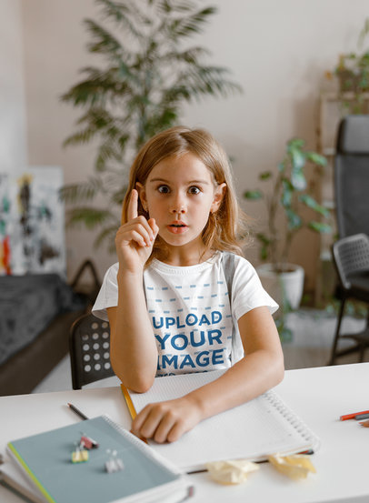 T-Shirt Mockup Featuring a Surprised Girl Sitting on a Desk With School Supplies m17787 r-el2
